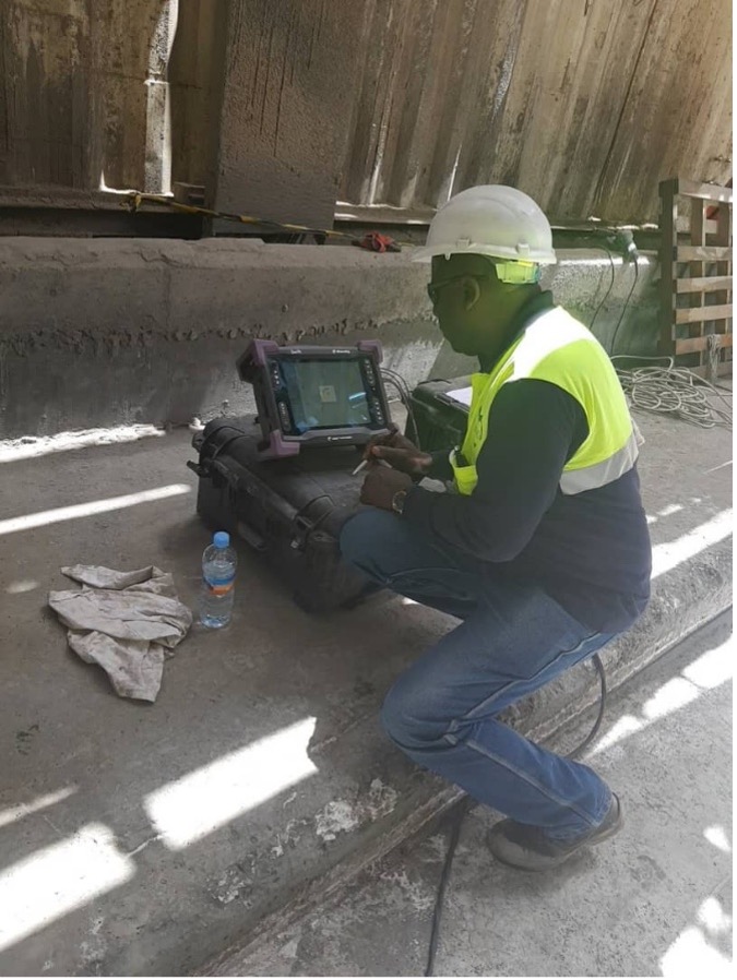 NDT technician performing ultrasonic inspection on industrial piping
